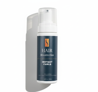 Hair resurrection mousse with a white pump on a gray background